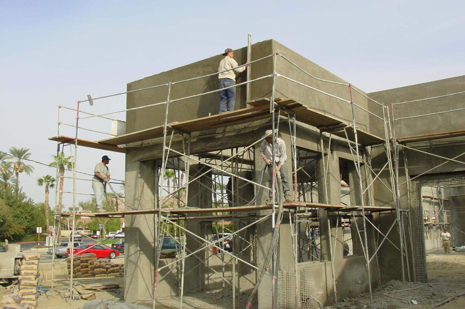 A group of construction workers are working on a building.