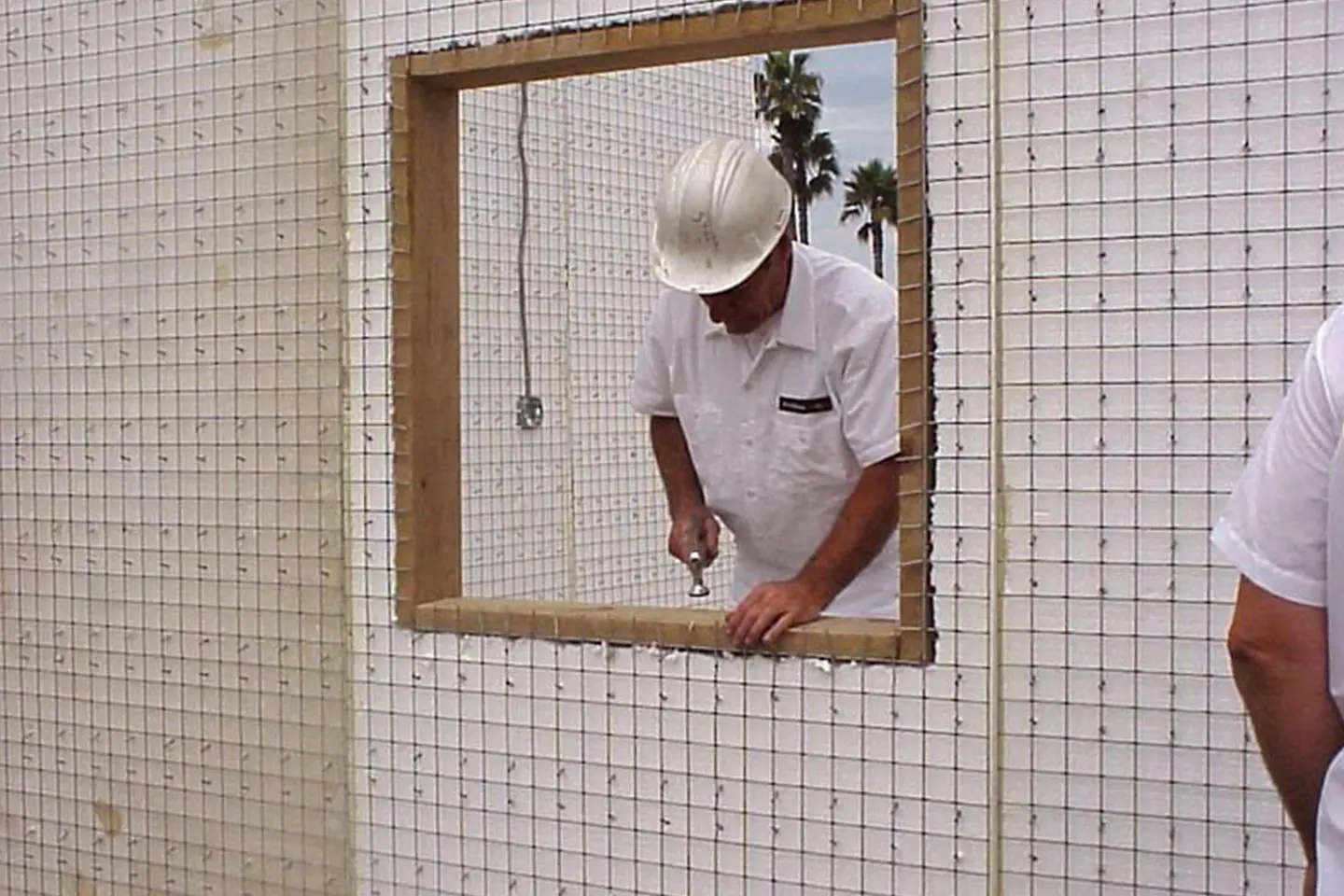 Construction worker installing window frame.