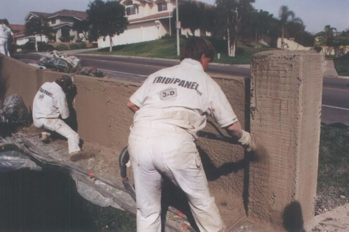 A man in white is painting the wall