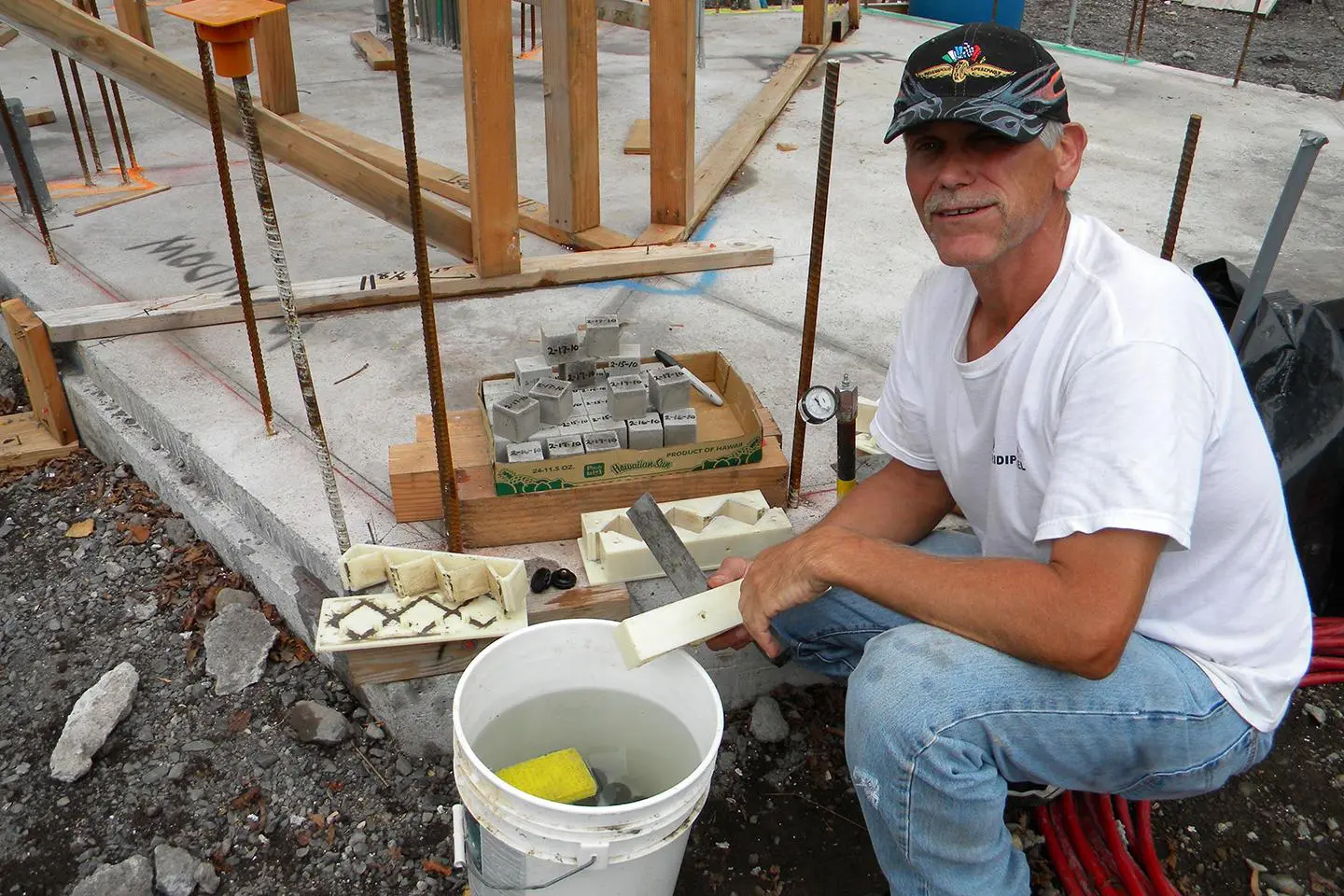 A man sitting on the ground with some food.