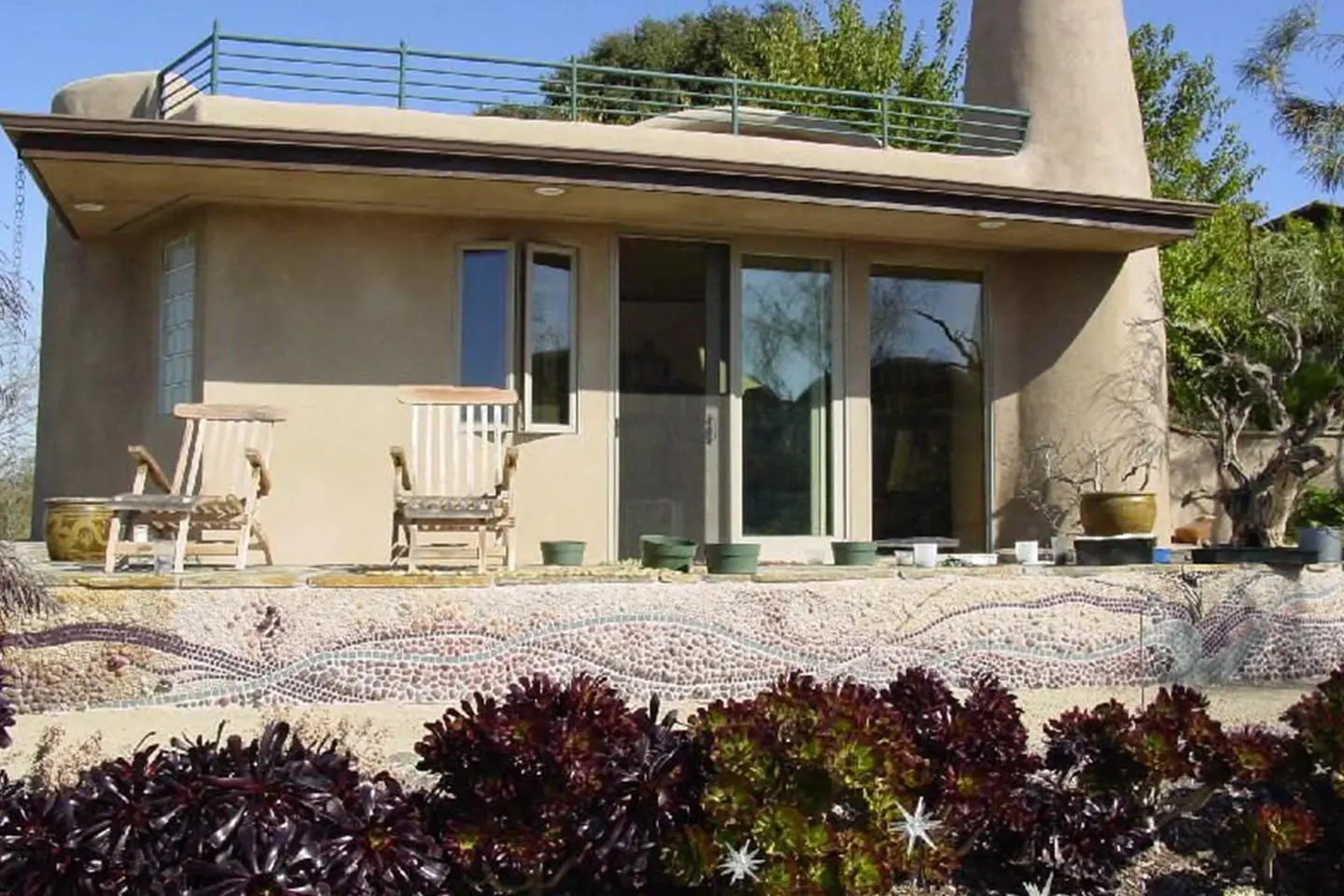 A house with a patio and garden furniture.