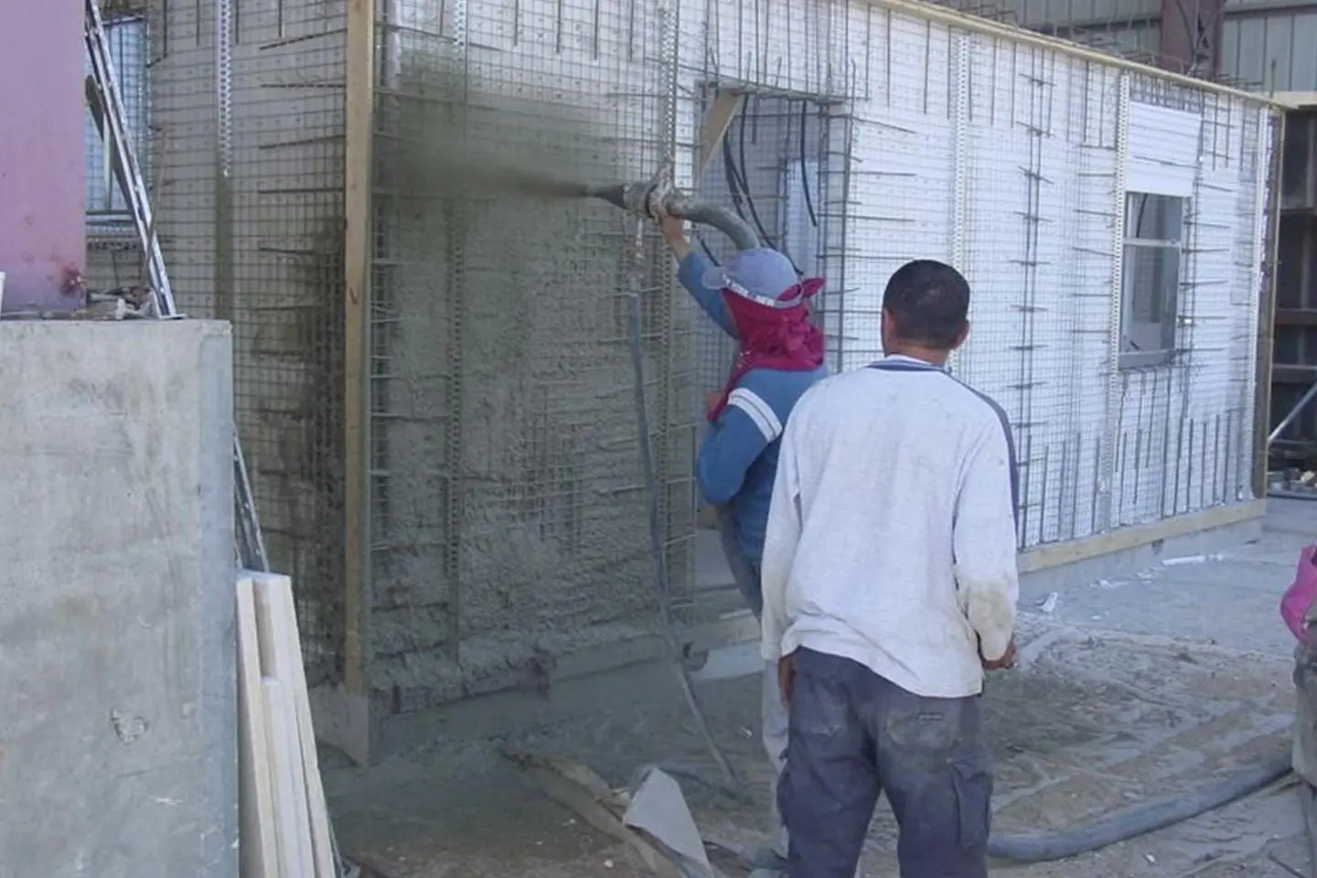 A man is hanging on the wall of a building