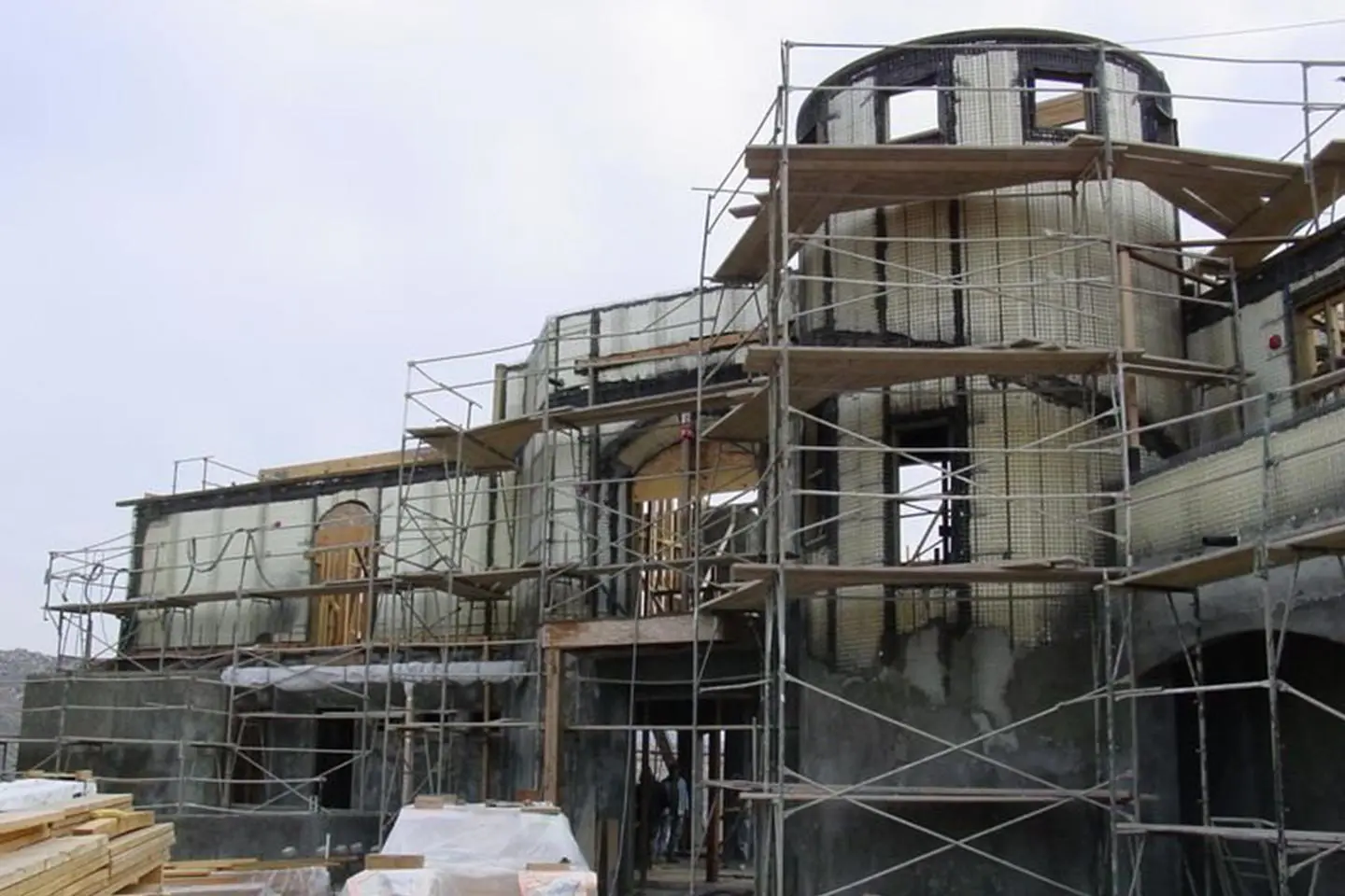 A building with scaffolding around it and a sky background