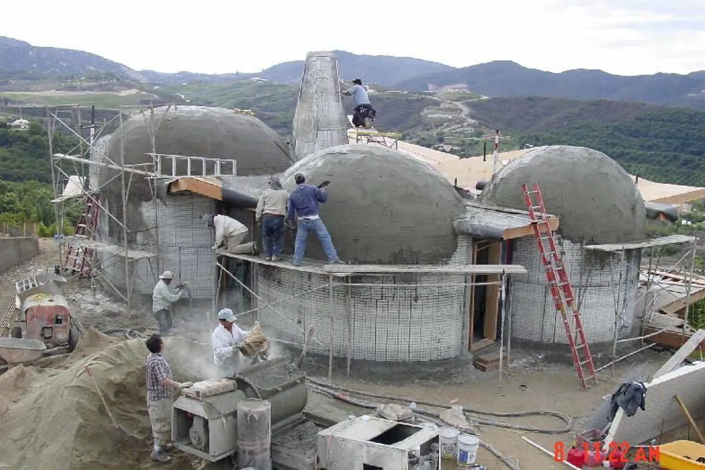 Construction workers building a dome house.