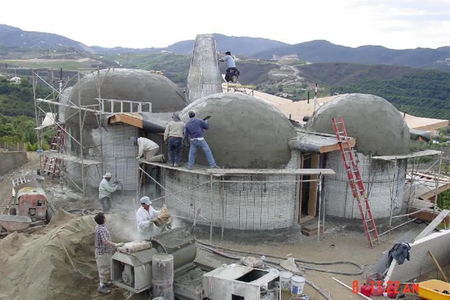 Construction workers building a dome house.