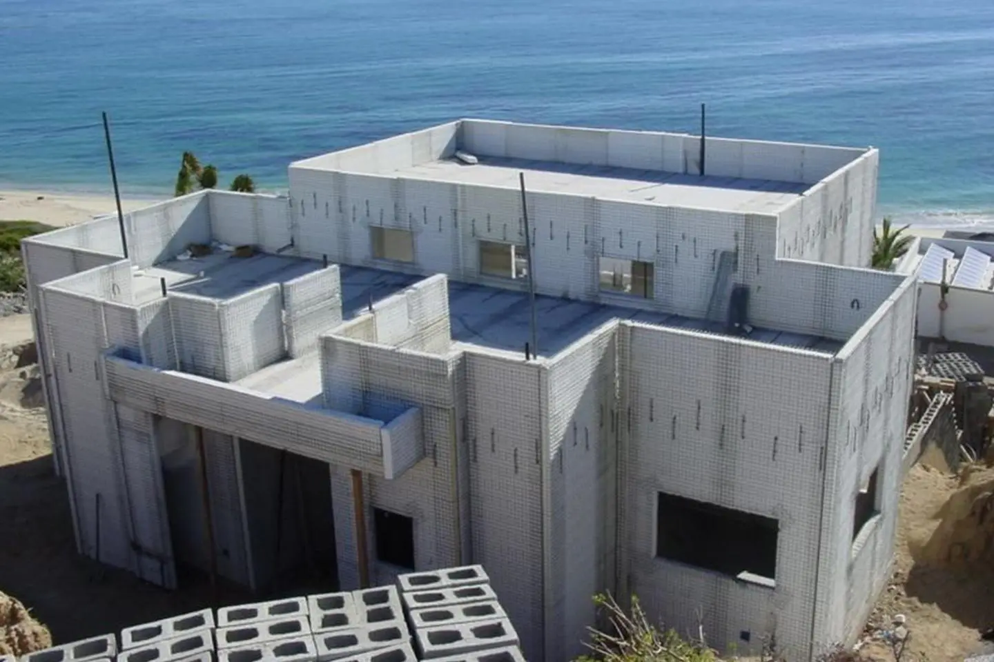 A house under construction near the ocean.