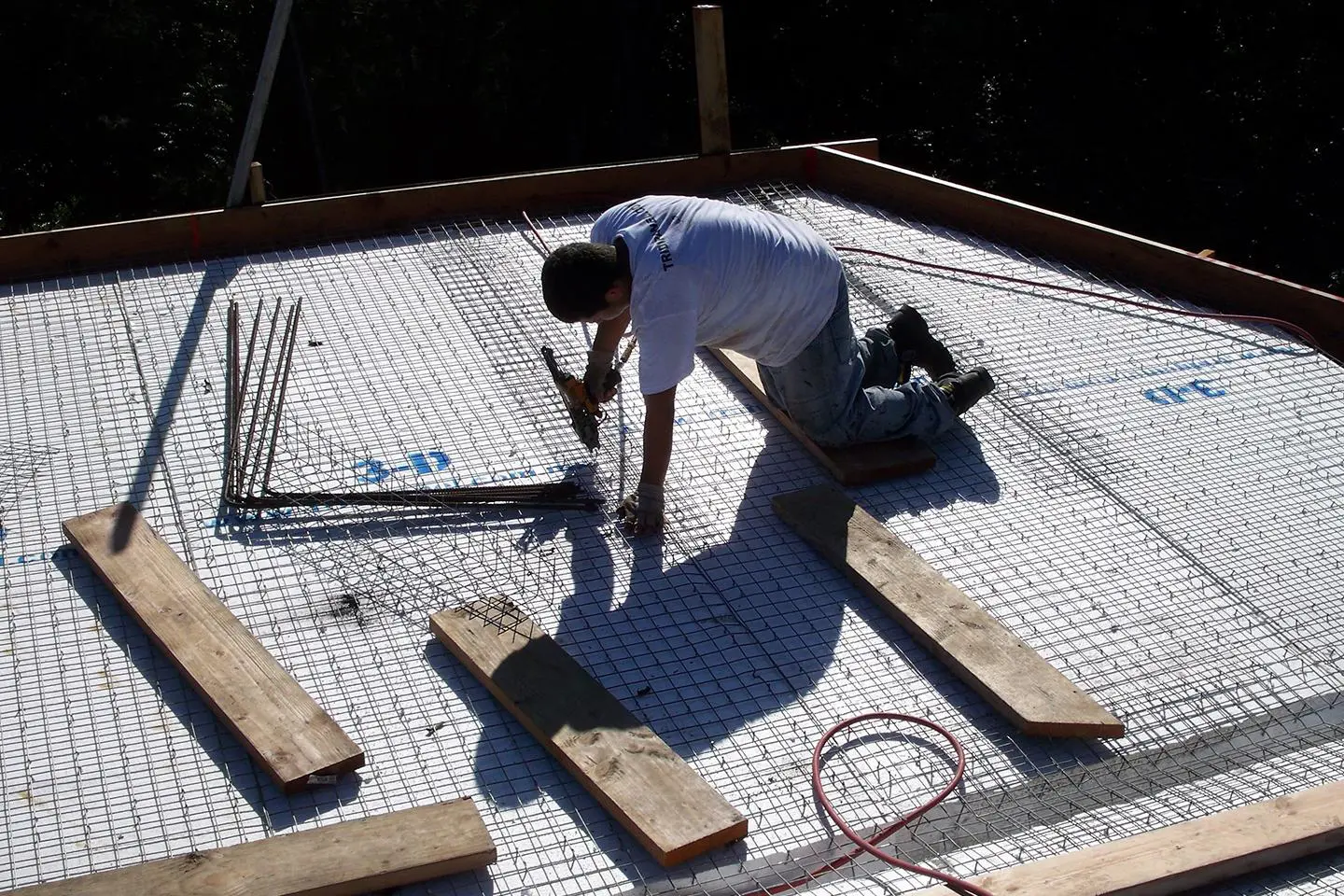 A man working on the ground in front of him.