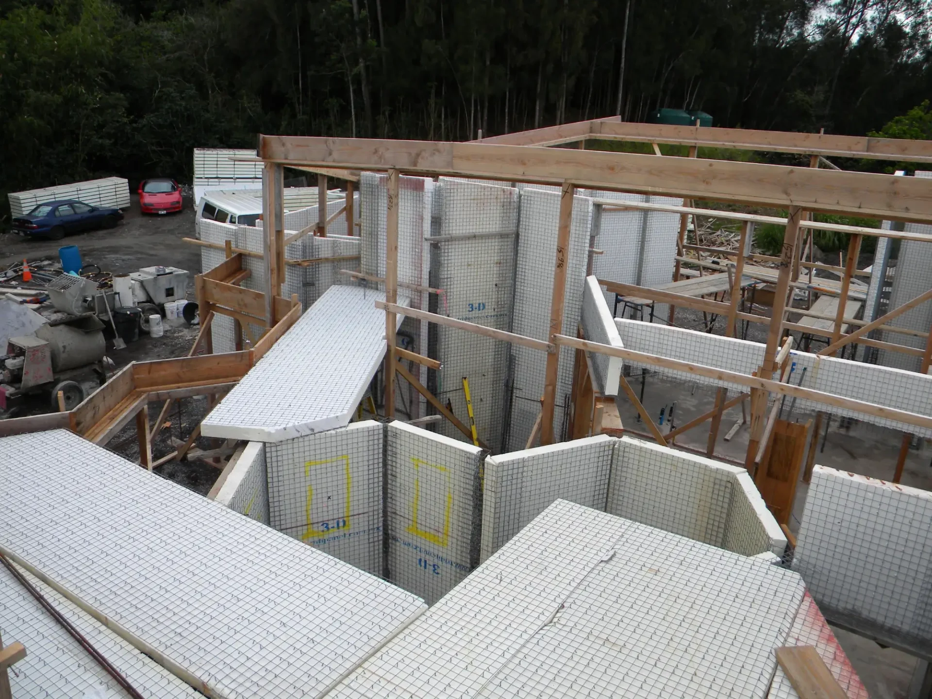 House under construction with wire mesh walls.