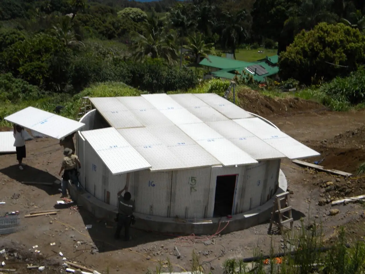 Construction workers building a round structure.