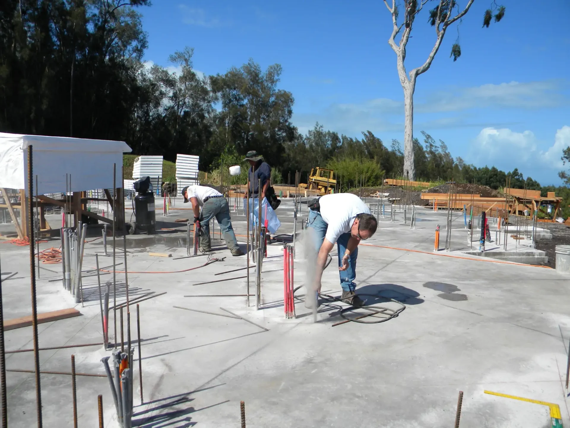 Construction workers on a concrete slab.