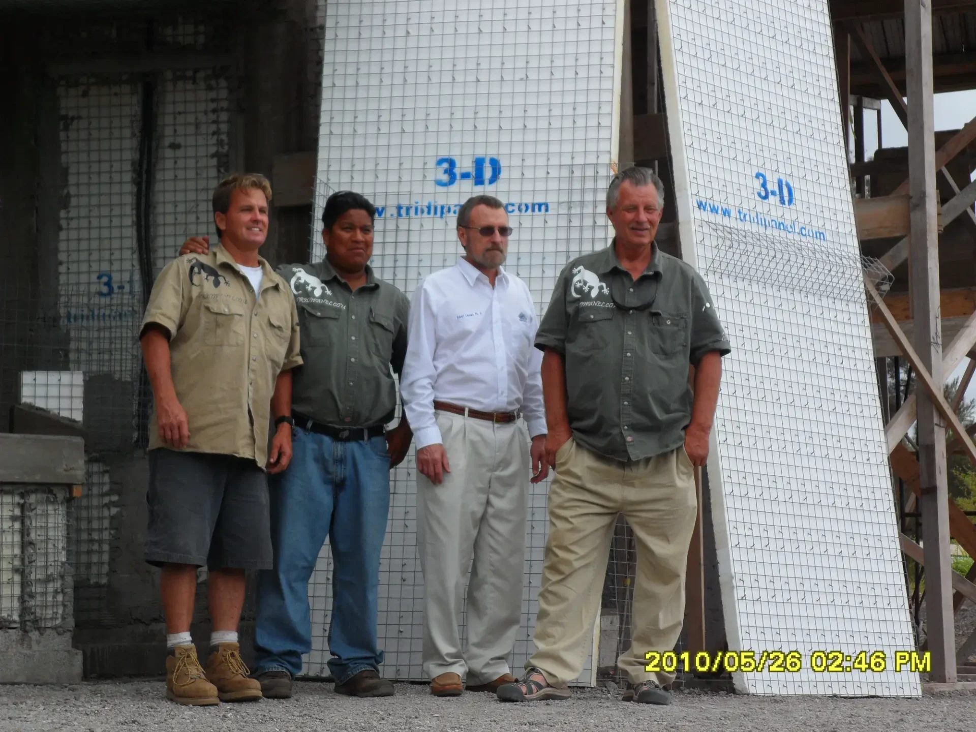 Four men standing in front of a building.